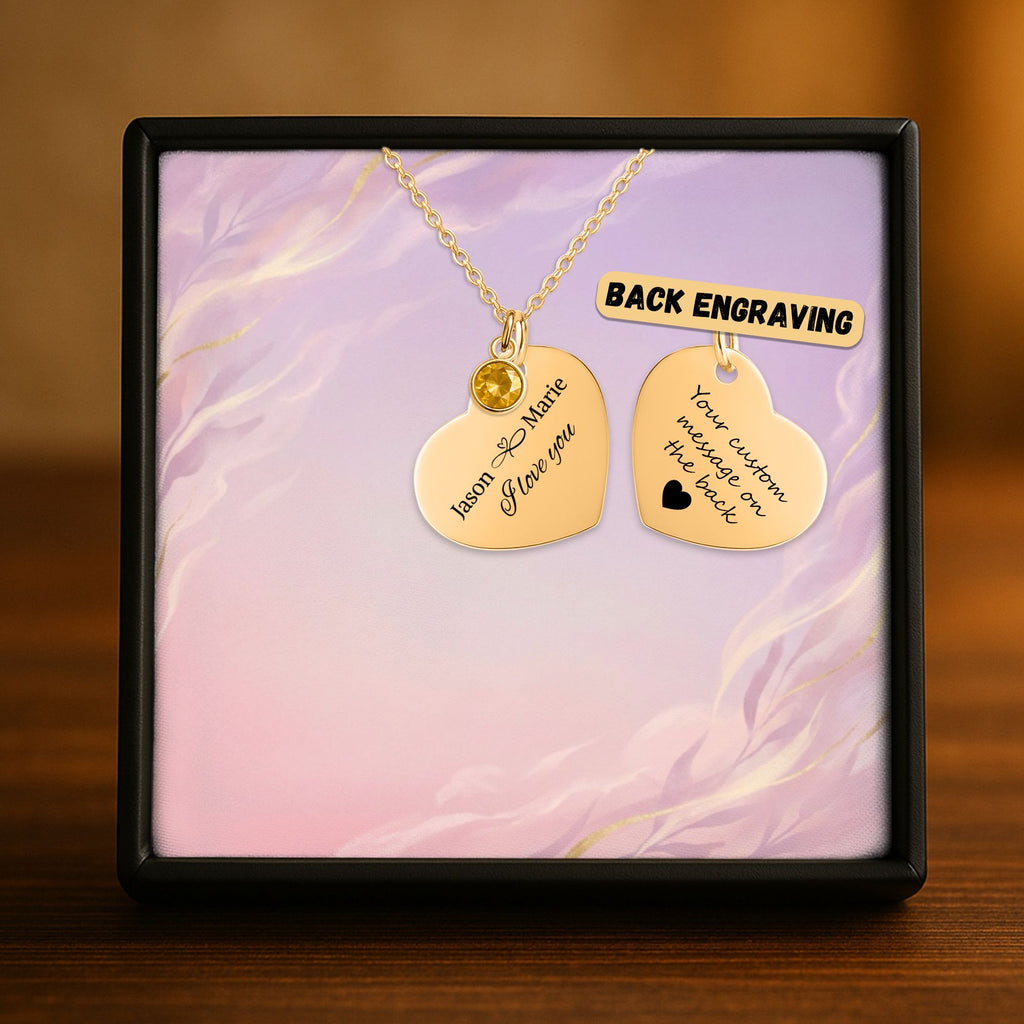 De gouden hartketting met geboortesteen in het geschenkdoosje, met de achterkant ernaast