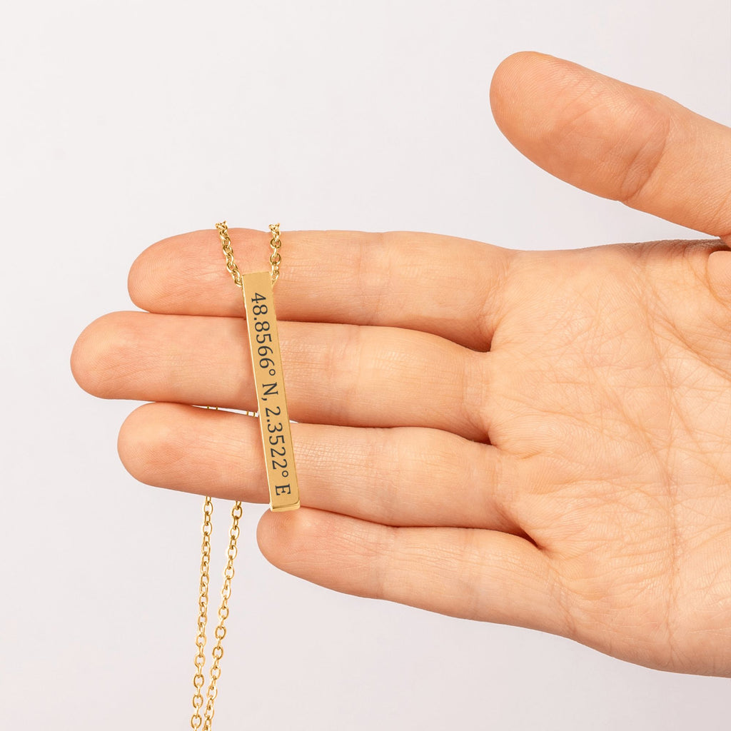 De gouden 3D-staafketting, in de hand gehouden