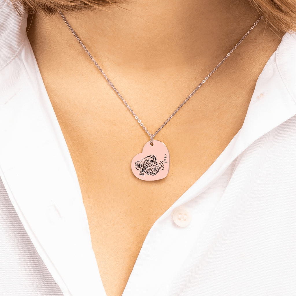 De roségouden hartketting om de hals gedragen